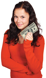 girl with orange sweater holding money