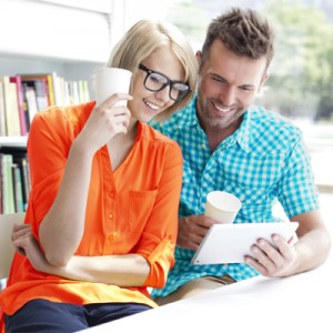 Couple in library working with digital tablet