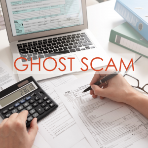 a desk filled with papers, a calculator, pen, and laptop | Ghost Scam