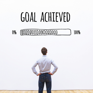 Man standing in front of a wall with "Goal Achieved" written on the wall. Avoid Holiday Impulse Shopping