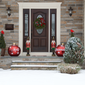 Brick home front door with Christmas wreath and decorations. Avoid Holiday Travel Stress