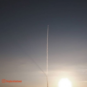rocket lauching into the sky at sunset