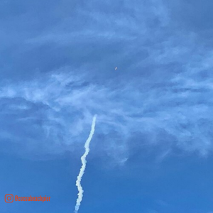 rocket going up into blue sky 