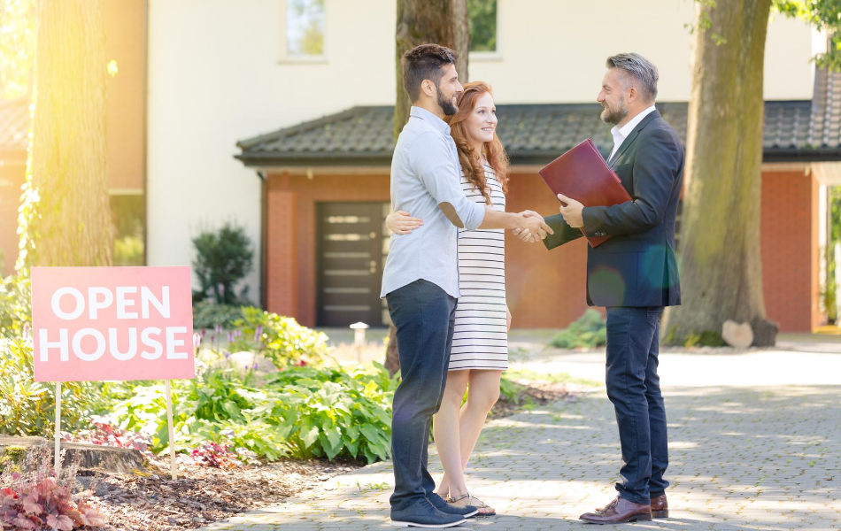 Couple shaking hands with real estate agent