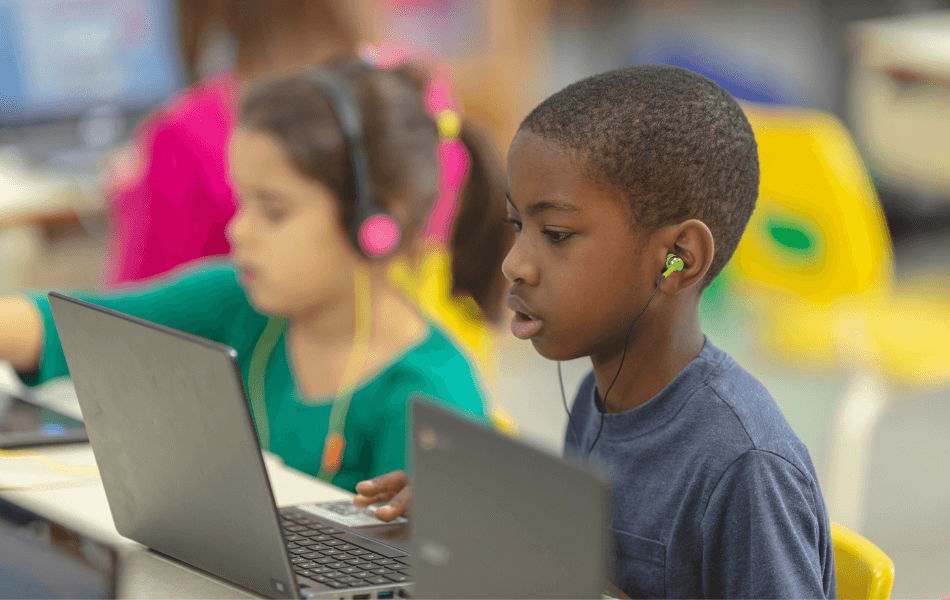 Kid looking at a laptop