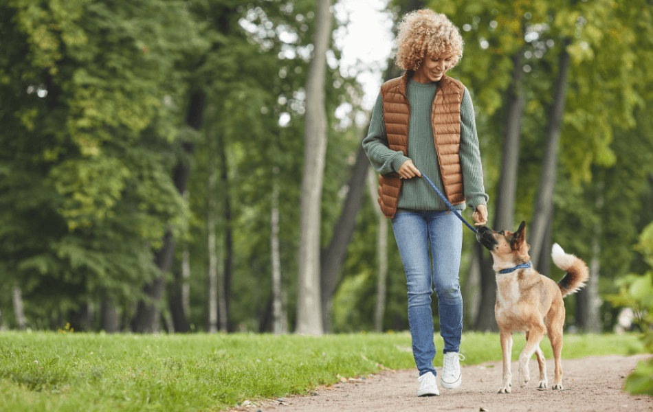 woman walking a dog outside