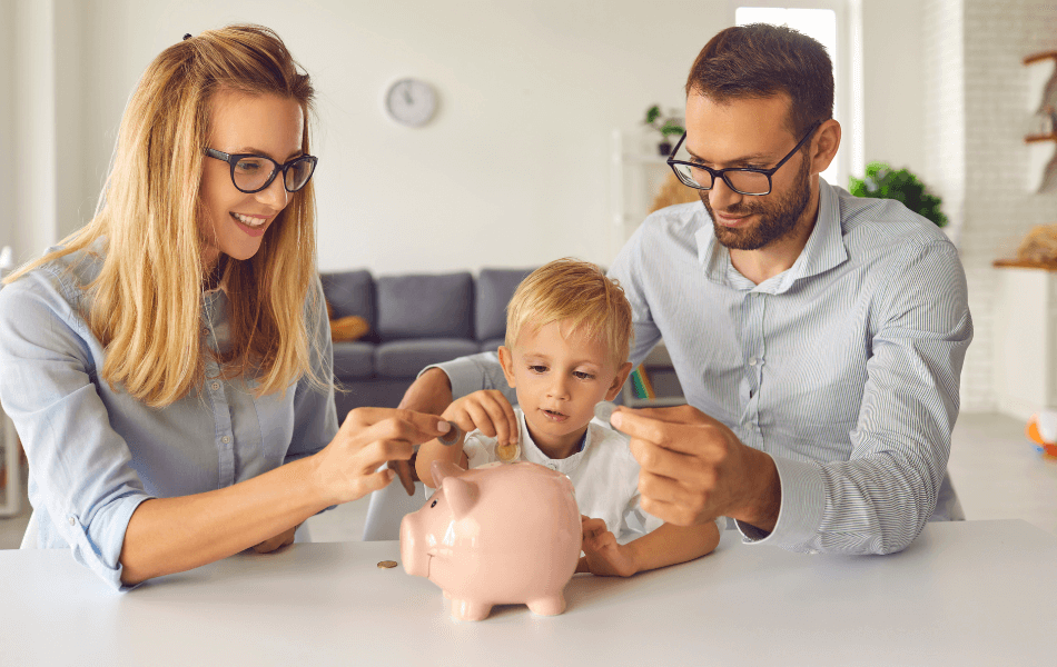 parents and a child putting money into a piggy bank