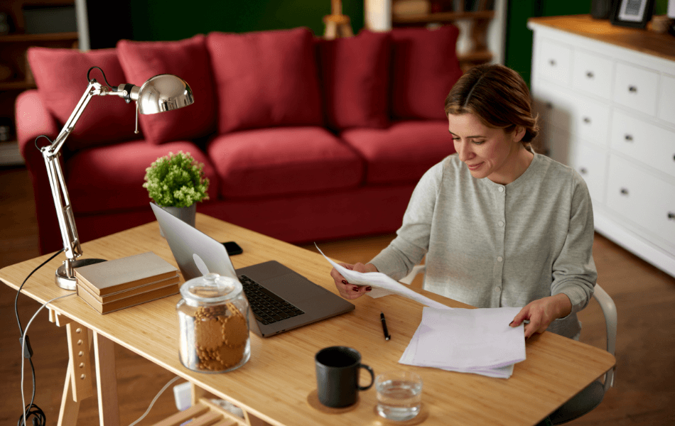 Person looking over bank statement at their desk