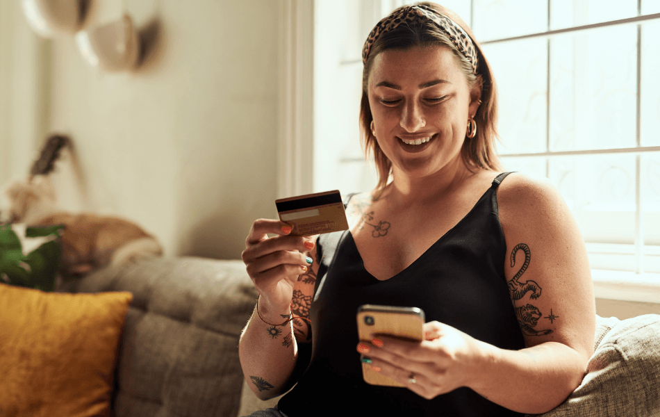Woman looking at phone and card