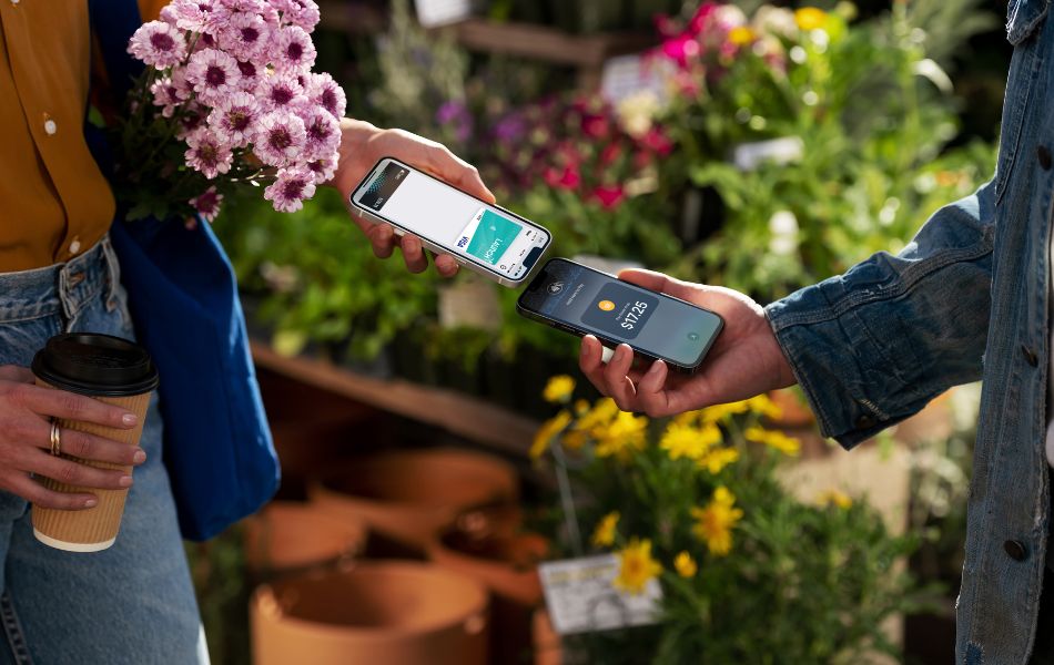 Woman Scanning Mobile Wallet at Flower Shop
