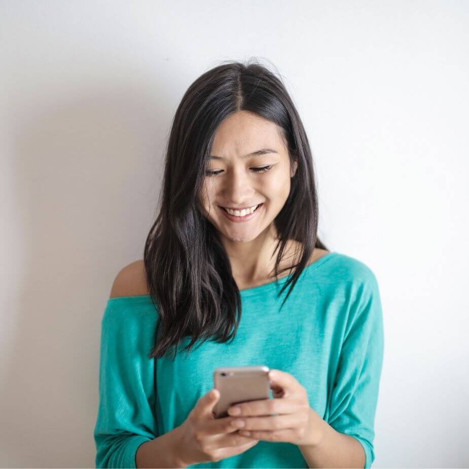 Woman smiling looking at phone