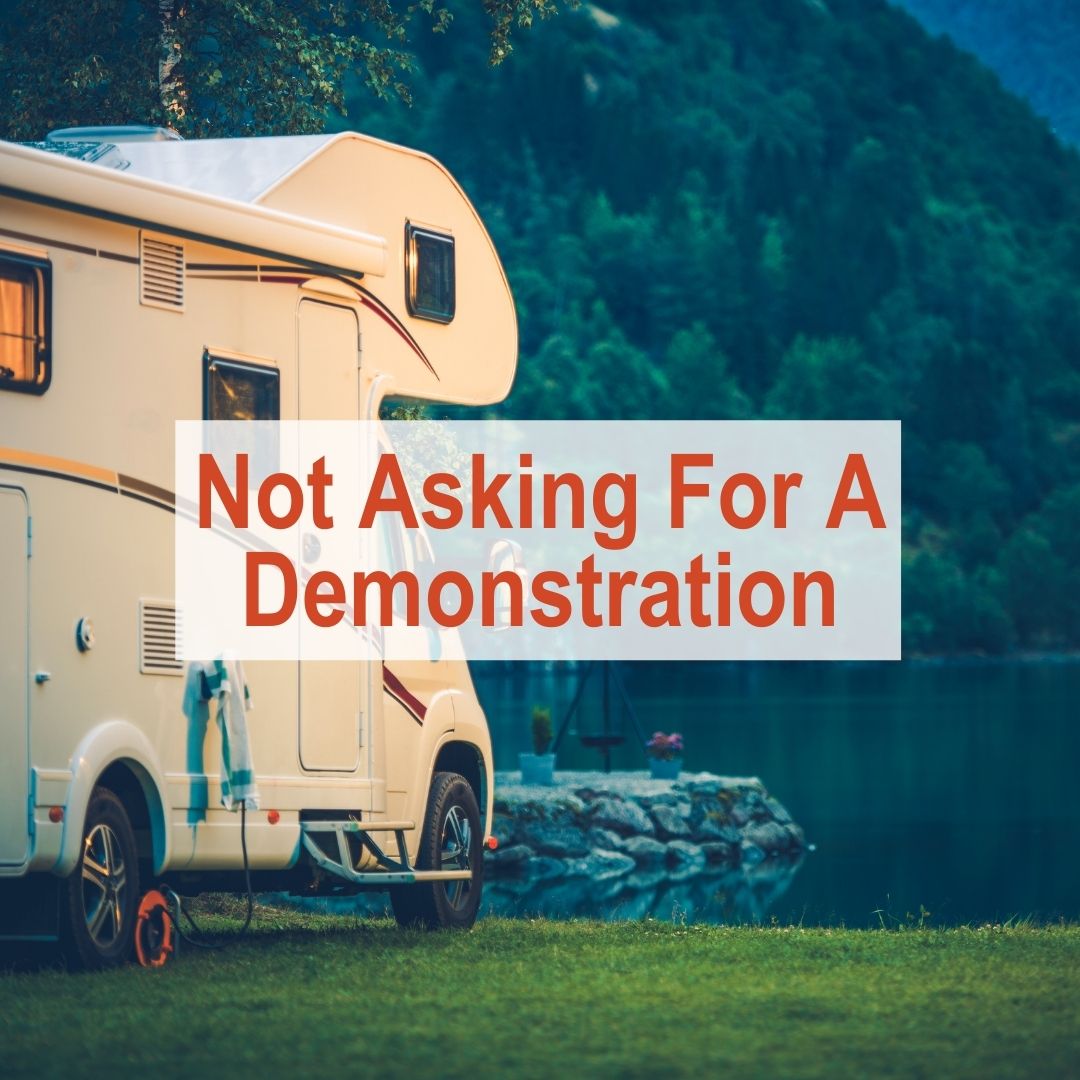 RV facing lake in woods | Not asking for a demonstration