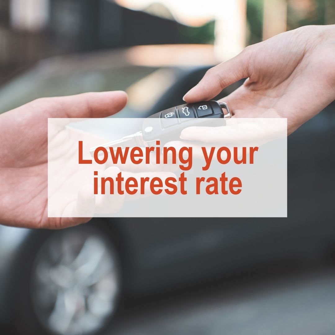 Person handing over car key with car in the background | Lowering Your Interest Rate