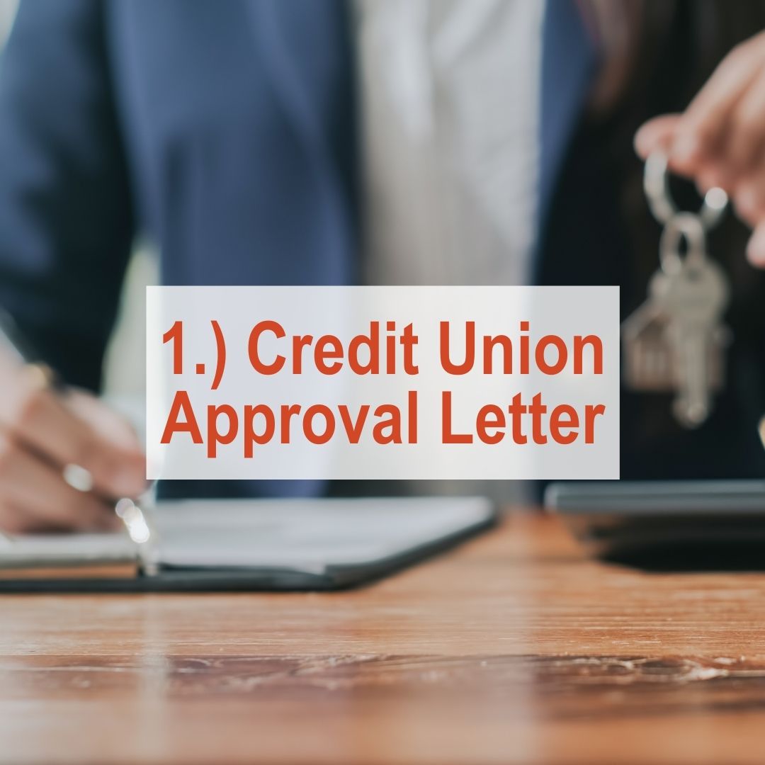 close up of hand writing on table holding keys in other hand | Credit Union Approval Letter