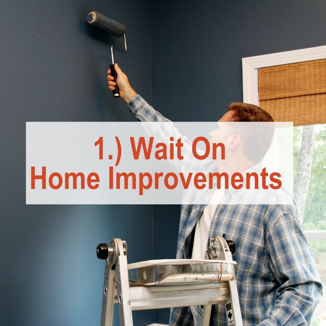 A man painting a wall grey | Wait On Home Improvements