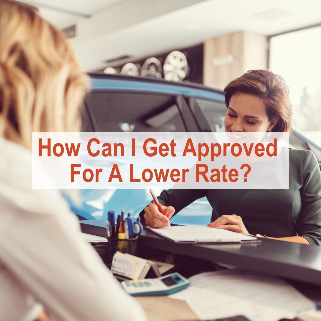salesperson at car dealership talking to someone | How To Get Approved For A Lower Rate